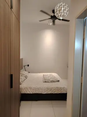 a bedroom with a bed and a ceiling fan at Cosy Townhouse in Tasek Gelugor in Ara Rendang