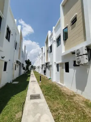a row of white buildings with air conditioners at Cosy Townhouse in Tasek Gelugor in Ara Rendang