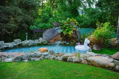 a pool with a inflatablevisor in the middle of a yard at Villa Sapphire by Blue Robin - Private Taiping Villa 20pax River & Waterfall in Taiping
