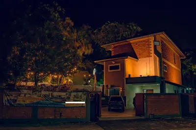 a house with a fence in front of it at night at Villa Sapphire by Blue Robin - Private Taiping Villa 20pax River & Waterfall in Taiping