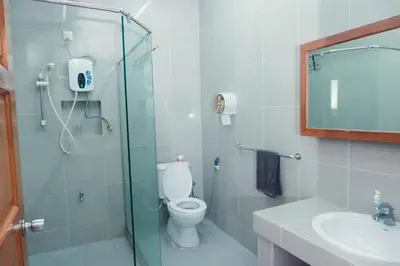a bathroom with a shower and a toilet and a sink at Villa Sapphire by Blue Robin - Private Taiping Villa 20pax River & Waterfall in Taiping