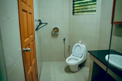 a bathroom with a toilet and a sink at Villa Sapphire by Blue Robin - Private Taiping Villa 20pax River & Waterfall in Taiping