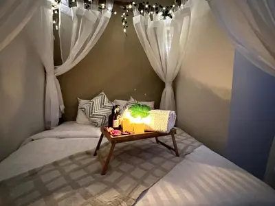 a small bedroom with two beds with a table with a table at The Little Bali Romance 2pax#Private Bathroom#2min KekLokSi in Ayer Itam