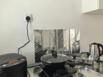 a pot on top of a stove in a kitchen at Padang Serai Wangi Homestay in Padang Serai