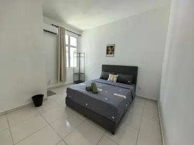 a bedroom with a bed in a room with a window at Padang Serai Wangi Homestay in Padang Serai