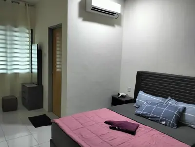 a bedroom with a bed with a pink blanket on it at Homestay Panda Seri Iskandar Location nearby Uitm Utp KPM in Seri Iskandar