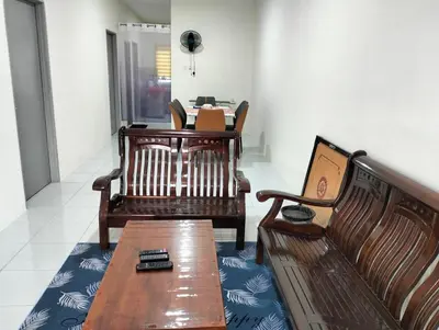 a room with three wooden benches and a table at Homestay Panda Seri Iskandar Location nearby Uitm Utp KPM in Seri Iskandar