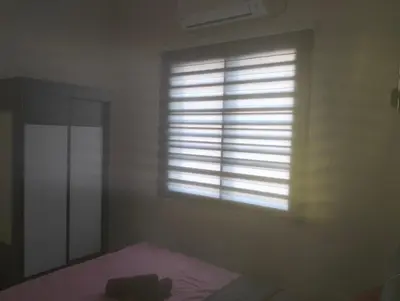 a window in a room with a bed and a mirror at Homestay Panda Seri Iskandar Location nearby Uitm Utp KPM in Seri Iskandar