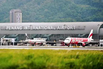 an airport with two airplanes parked at an airport at EEs Ocean House - Homestay 3 min walk to beach in Batu Ferringhi