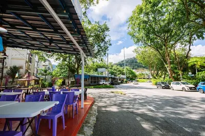 a group of blue tables and chairs on a street at EEs Ocean House - Homestay 3 min walk to beach in Batu Ferringhi