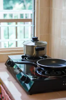 a pot on top of a stove in a kitchen at EEs Ocean House - Homestay 3 min walk to beach in Batu Ferringhi