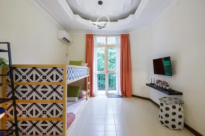 a room with a crib and a large window at EEs Ocean House - Homestay 3 min walk to beach in Batu Ferringhi
