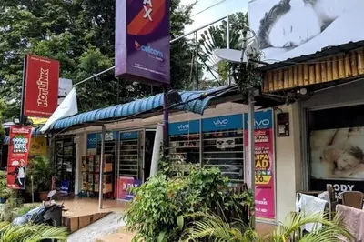 a store with signs on the side of a street at EEs Ocean House - Homestay 3 min walk to beach in Batu Ferringhi