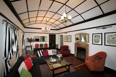 a living room with a couch and a fireplace at Bukit Lowick Bungalow in Tanah Rata