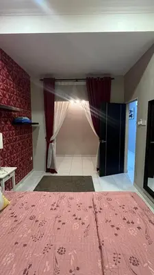 a bedroom with a pink bed and curtains in a room at Md homestay in Kampong Kubang Menderong