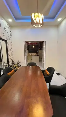 a conference room with a wooden table and chairs at Md homestay in Kampong Kubang Menderong