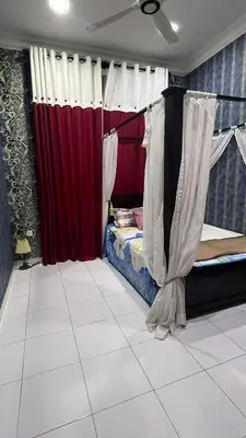a bedroom with two bunk beds and red curtains at Md homestay in Kampong Kubang Menderong