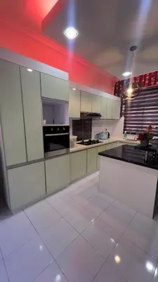 a large kitchen with white cabinets and a red ceiling at Md homestay in Kampong Kubang Menderong