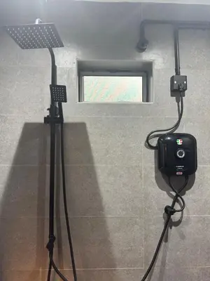 a camera on a tripod in a room with a window at Industrial Loft Tinyhouse Homestay - 2 Queen Bed, Free Netflix, Prime & Wi-Fi Near Bukit Mertajam in Kubang Semang