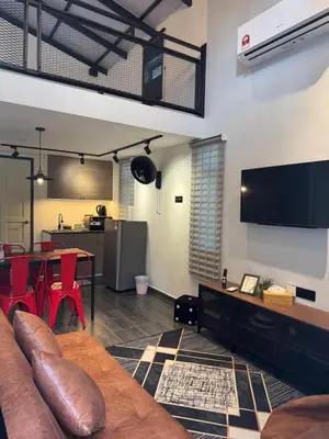 a living room with a couch and a table at Industrial Loft Tinyhouse Homestay - 2 Queen Bed, Free Netflix, Prime & Wi-Fi Near Bukit Mertajam in Kubang Semang