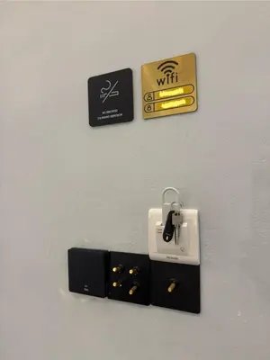 a wall with an electric outlet and a box on it at Industrial Loft Tinyhouse Homestay - 2 Queen Bed, Free Netflix, Prime & Wi-Fi Near Bukit Mertajam in Kubang Semang