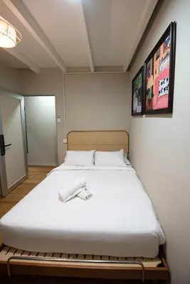 a bedroom with a bed with a white blanket at DeLuma - Lebuh Melayu 4 Bedroom in George Town