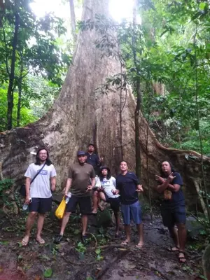 a group of people standing in front of a tree at House boat in Gerik