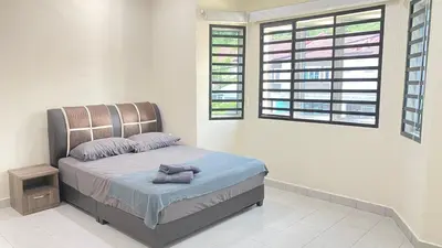 a bedroom with a bed and a window at Assyifa Homestay Kulim in Kulim