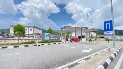 an empty road with a gas station and a car at Assyifa Homestay Kulim in Kulim