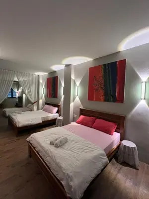 a bedroom with two beds with red pillows at Penang Georgetown studio home in George Town