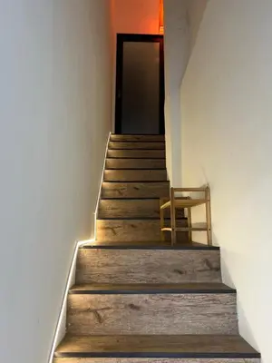 a stairway with a chair and a door at Penang Georgetown studio home in George Town