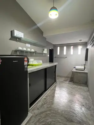 a kitchen with a black refrigerator and a counter at Penang Georgetown studio home in George Town