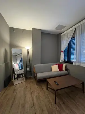 a living room with a couch and a table at Penang Georgetown studio home in George Town