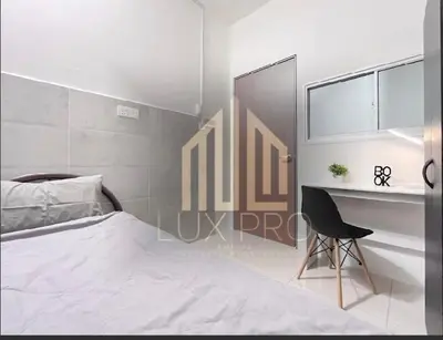 a white bedroom with a bed and a desk at Residensi prima kampung paloh in Ipoh