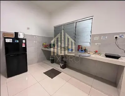 a kitchen with a counter and a black refrigerator at Residensi prima kampung paloh in Ipoh