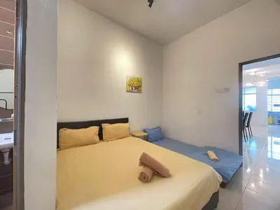 a bedroom with a large bed in a room at Jovial Single Storey Cozy Haus 9Pax in Lunas