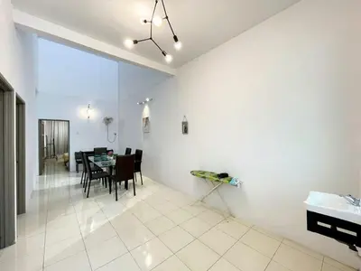 a living room with a table and a dining room at Jovial Single Storey Cozy Haus 9Pax in Lunas