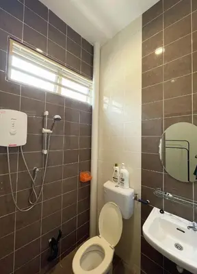 a bathroom with a shower and a toilet and a sink at Jovial Single Storey Cozy Haus 9Pax in Lunas