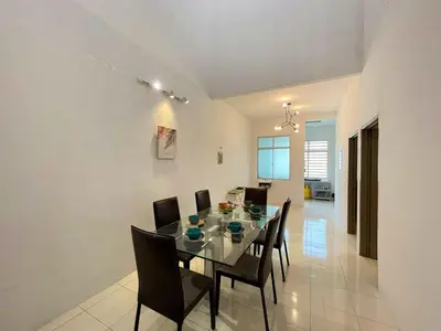 a dining room with a glass table and chairs at Jovial Single Storey Cozy Haus 9Pax in Lunas