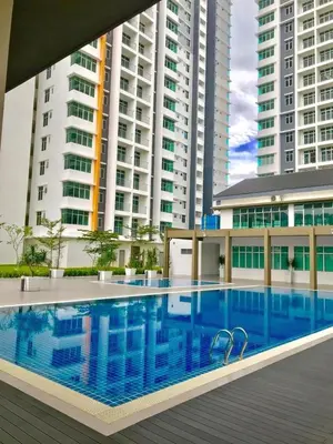 a swimming pool in front of some tall buildings at Prima Resident Meru Ipoh in Ipoh