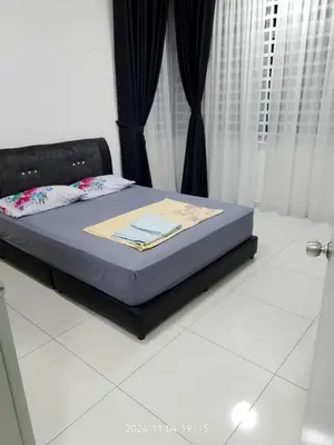 a bed in a bedroom with a blue mattress at Prima Resident Meru Ipoh in Ipoh