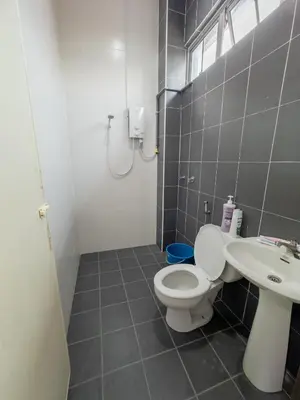 a bathroom with a toilet and a sink at Hi-Tea HomeStay in Sungai Petani