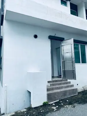a white building with stairs and a door at Homestay Bintang Maya in Sungai Petani