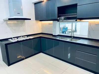 a kitchen with blue cabinets and a sink at Homestay Bintang Maya in Sungai Petani