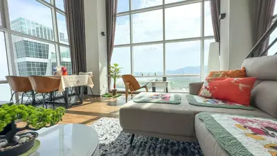a living room with a couch and a table at Penang Oceanview Loft in George Town