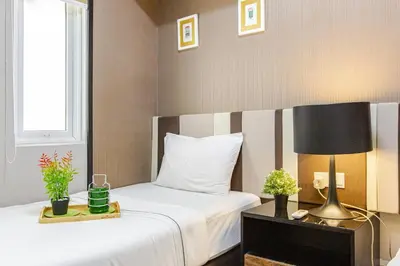 a bedroom with a bed and a lamp and a window at Penang Oceanview Loft in George Town