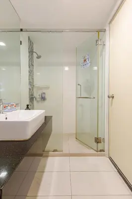 a bathroom with a sink and a glass shower at Penang Oceanview Loft in George Town