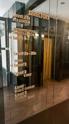 a glass door with signs on the side of a building at Penang Oceanview Loft in George Town