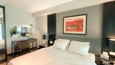 a bedroom with a white bed and a desk with a desk at Penang Oceanview Loft in George Town