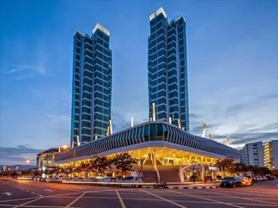 a building with two tall buildings in a parking lot at Penang Oceanview Loft in George Town